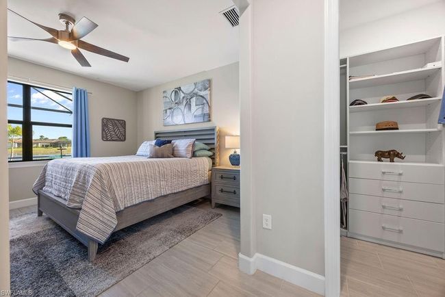 Bedroom featuring a ceiling fan, baseboards, and visible vents | Image 18