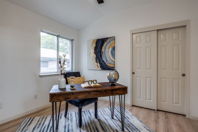 Office area featuring light wood-style flooring, baseboards, and vaulted ceiling | Image 15