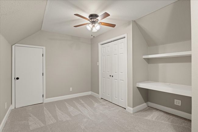 Additional living space featuring vaulted ceiling, carpet floors, and a ceiling fan | Image 14