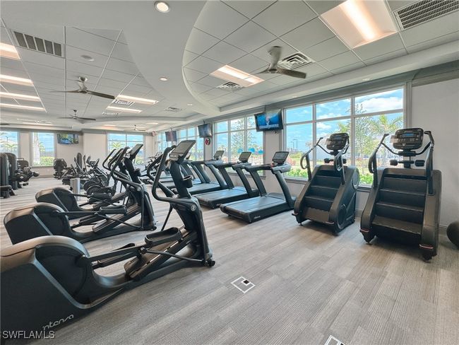 Workout area featuring carpet flooring and a paneled ceiling | Image 42