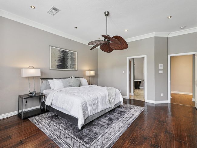 Bedroom featuring hardwood / wood-style flooring, recessed lighting, crown molding, and a ceiling fan | Image 24