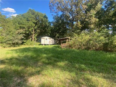 View of yard with a storage unit | Image 2