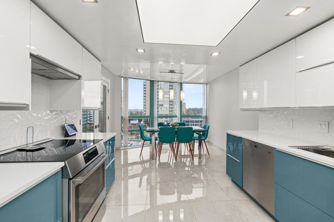 Kitchen featuring blue cabinetry, light countertops, stainless steel appliances, and backsplash | Image 14