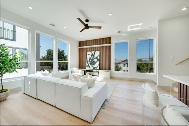 Living room featuring light hardwood / wood-style floors and ceiling fan | Image 7