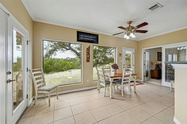 Light and airy, you can enjoy the outdoors without fighting the elements in this breakfast/flex room. | Image 12