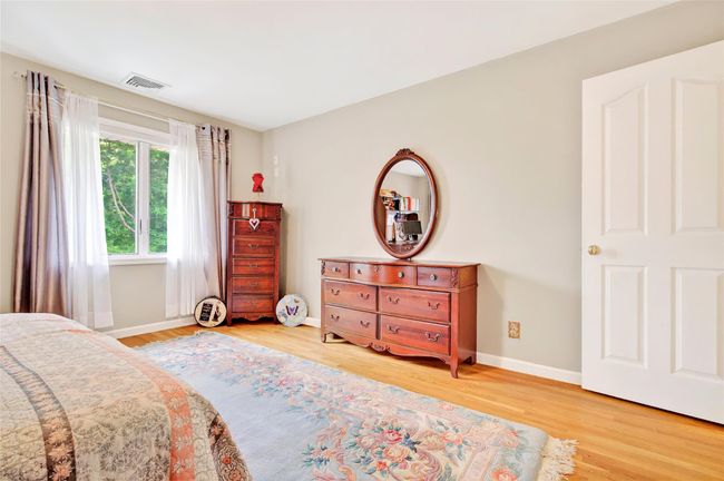 Bedroom featuring wood finished floors and baseboards | Image 38