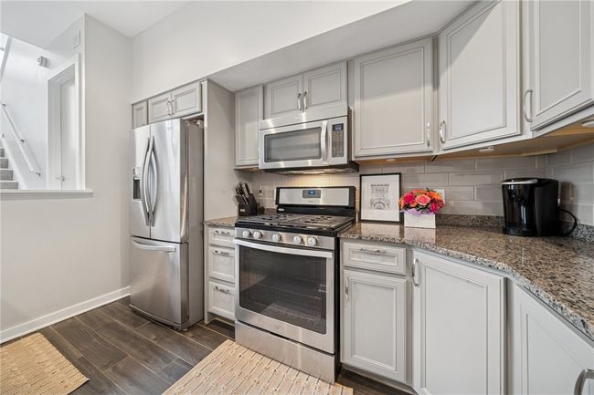 The kitchen is tastefully updated with granite countertops. | Image 8