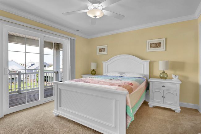 Bedroom featuring light colored carpet, access to outside, ornamental molding, and ceiling fan | Image 17