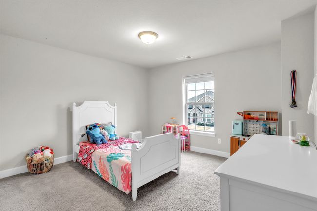 Bedroom with visible vents, light carpet, and baseboards | Image 22