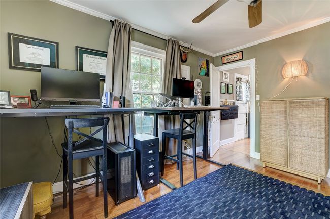 Bar with ornamental molding, wood finished floors, and ceiling fan | Image 21