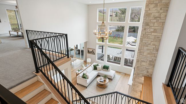 Staircase with baseboards, a high ceiling, a notable chandelier, visible vents, and recessed lighting | Image 35