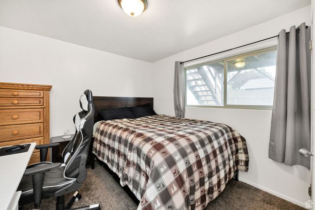 Bedroom with dark carpet and baseboards | Image 24