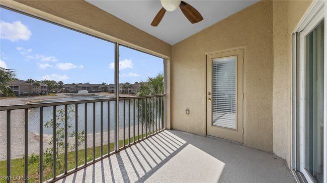 Balcony with ceiling fan and a water view | Image 16