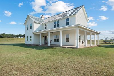 View of front of home featuring a porch, a front yard, and ceiling fan | Image 2