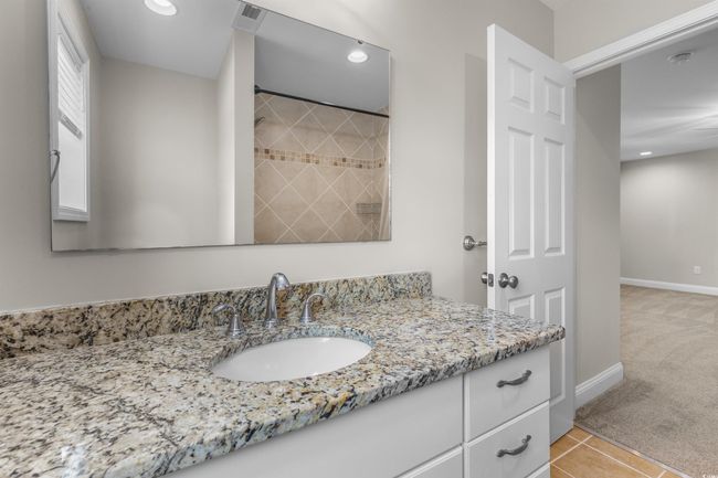 Full bath featuring vanity, baseboards, recessed lighting, a shower, and tile patterned flooring | Image 28