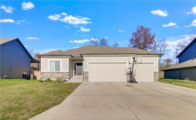 View of front of house with a front yard and a garage | Image 2