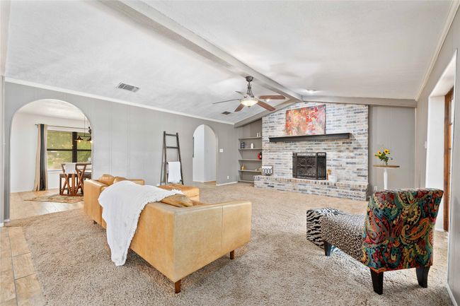 Living room with vaulted ceilings and wood burning fireplace | Image 11