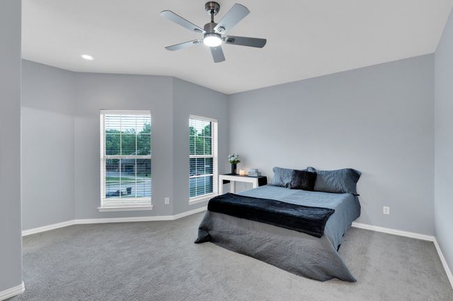 Bedroom featuring baseboards, a ceiling fan, and carpet | Image 28