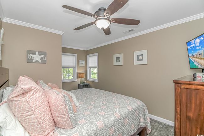 Carpeted bedroom with crown molding and a ceiling fan | Image 31