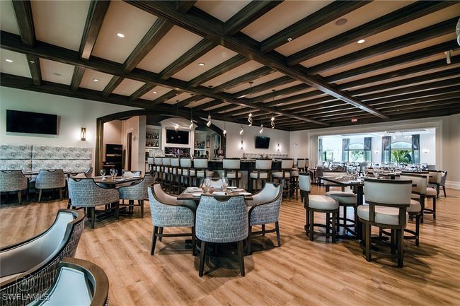 Dining room with beam ceiling, light wood-type flooring, and coffered ceiling | Image 28