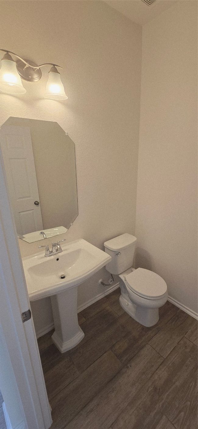 Bathroom with toilet and wood finished floors | Image 15