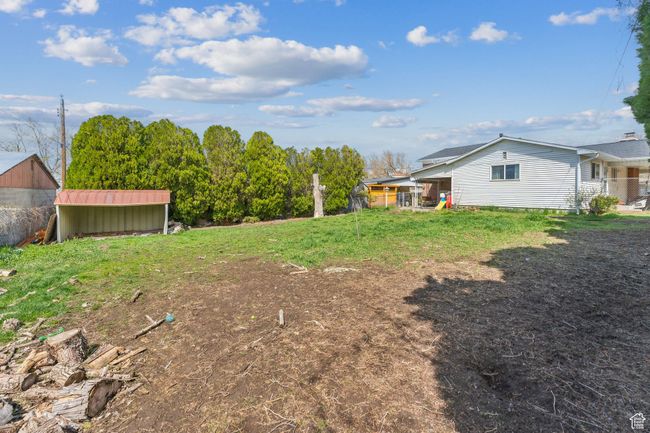 View of yard with an outdoor structure and a storage unit | Image 32