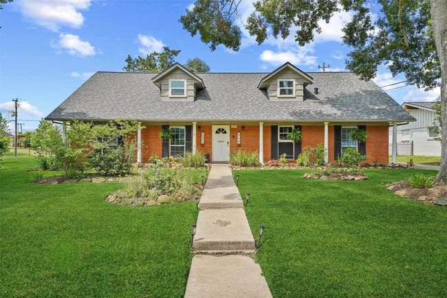 Charming curb appeal with manicured landscaping and a welcoming front porch. | Image 22