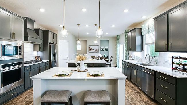 They say the kitchen is the heart of the home, and this one is a showstopper! With both informal and formal dining areas. | Image 9