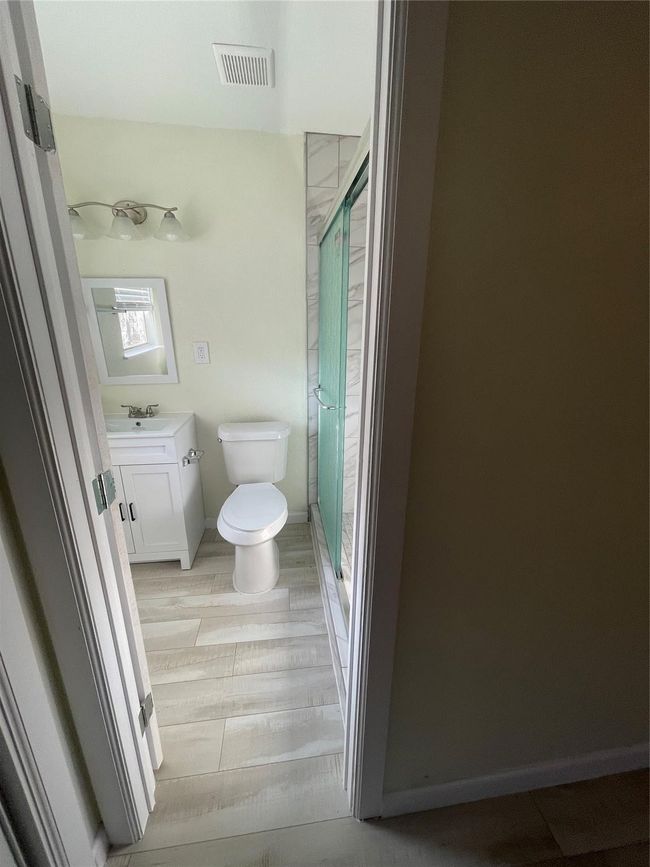 Full bath with toilet, a shower stall, vanity, and baseboards | Image 16