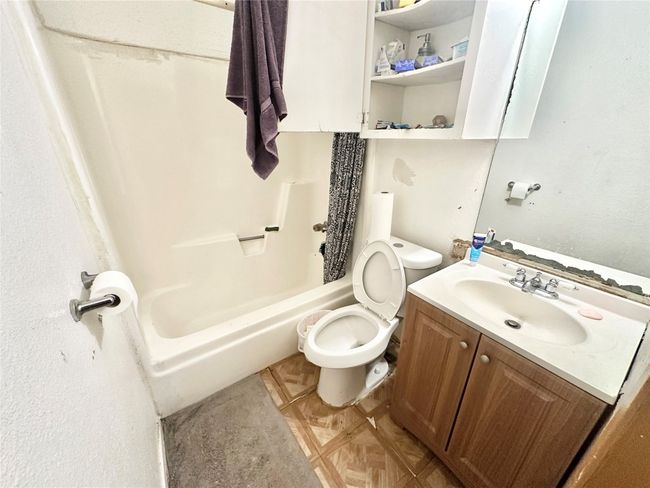 Full bath featuring toilet, vanity, and shower / bath combination | Image 31