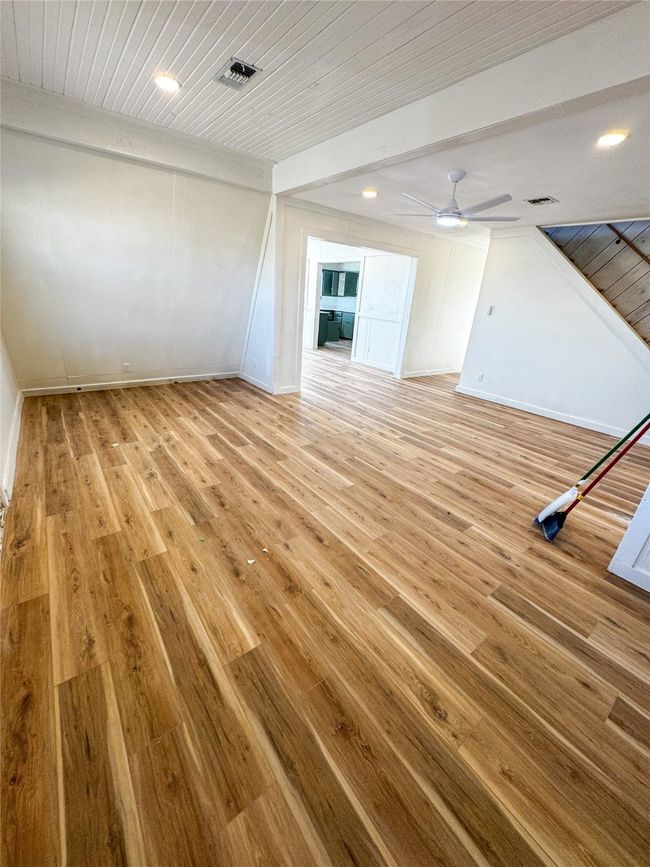 Unfurnished living room with wood ceiling, light wood-type flooring, visible vents, and ceiling fan | Image 15