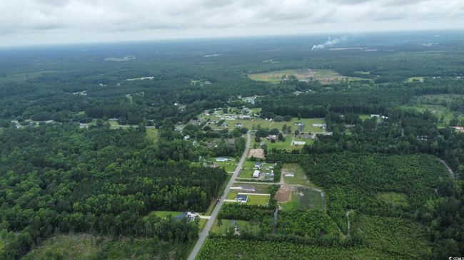 Aerial overview of property's location with a heavily wooded area | Image 7