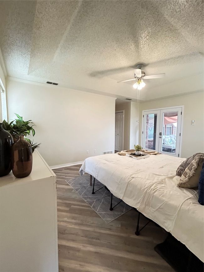 Bedroom with access to exterior, french doors, visible vents, and dark wood-type flooring | Image 31