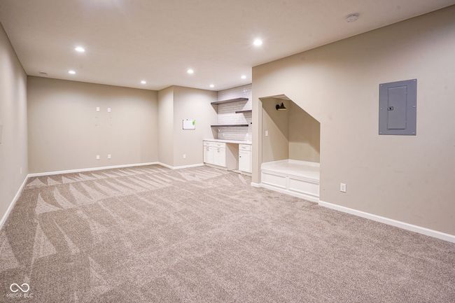 unfurnished living room with recessed lighting, light carpet, and electric panel | Image 35