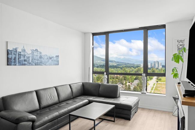Living room with plenty of natural light, light wood finished floors, and baseboards | Image 19