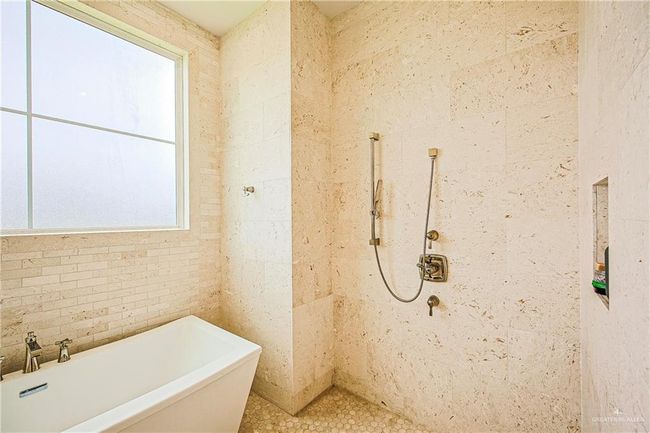 Full bathroom with a soaking tub, limestone tile, shower | Image 10