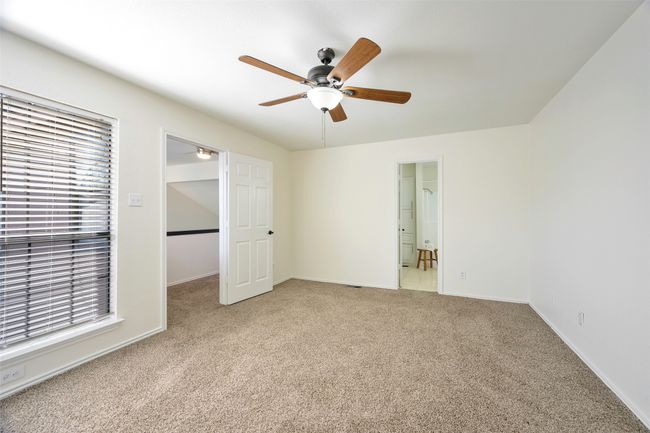 Unfurnished bedroom featuring ceiling fan, baseboards, and light carpet | Image 17