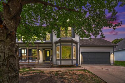 View of front facade with a front lawn | Image 1