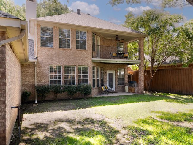 Rear view of property featuring a balcony, ceiling fan, brick siding, and a patio | Image 30