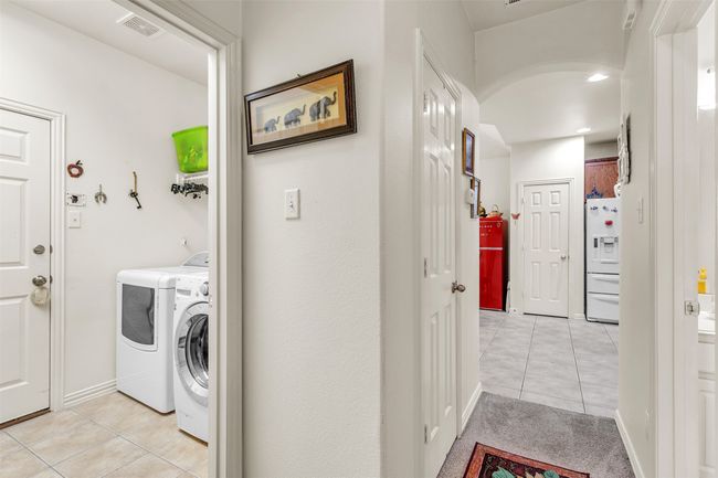 Washroom featuring light tile patterned floors and washer and dryer | Image 17