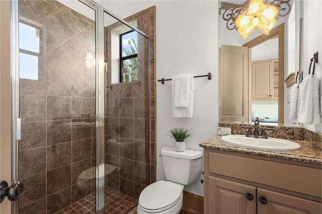 Pool bath next to the downstairs laundry and office nook. | Image 26