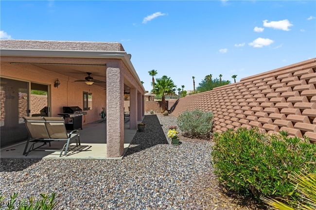 Fenced backyard with ceiling fan and a patio area | Image 47