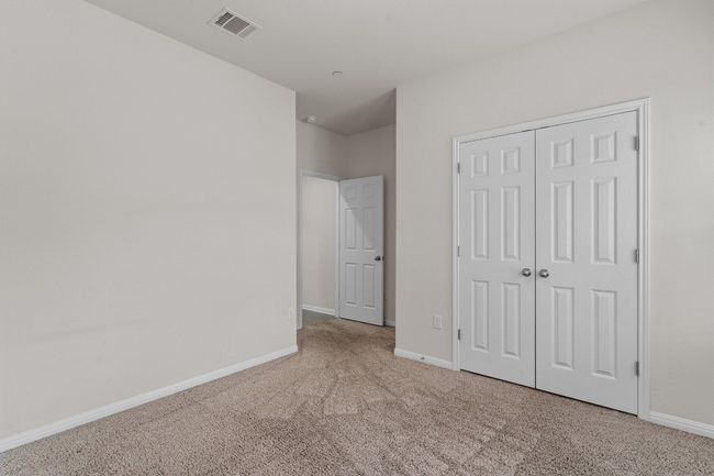 Unfurnished bedroom with carpet floors, baseboards, and a closet | Image 23