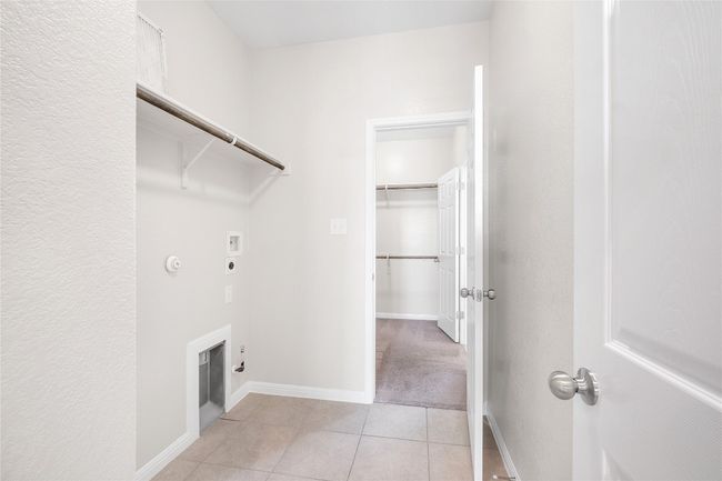 Laundry room featuring gas dryer hookup, electric dryer hookup, hookup for a washing machine, and light tile patterned flooring | Image 33