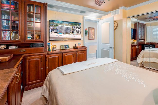 Bedroom with crown molding, light carpet, and a closet | Image 27
