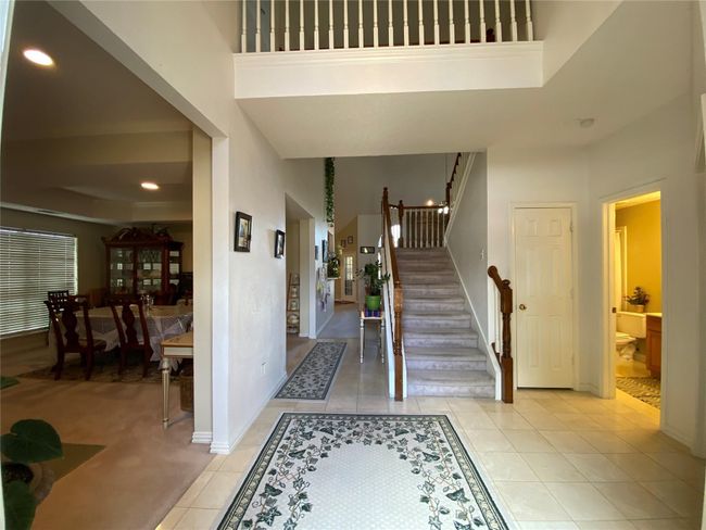 Tiled entryway featuring a tray ceiling | Image 5
