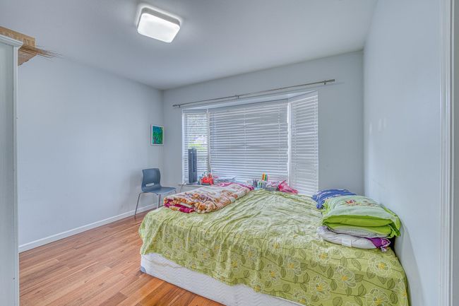 Bedroom with wood finished floors and baseboards | Image 24