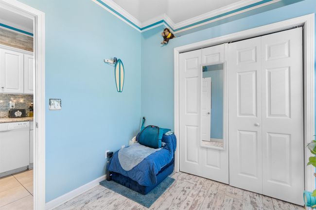Bedroom with crown molding, a closet, baseboards, and light wood finished floors | Image 20