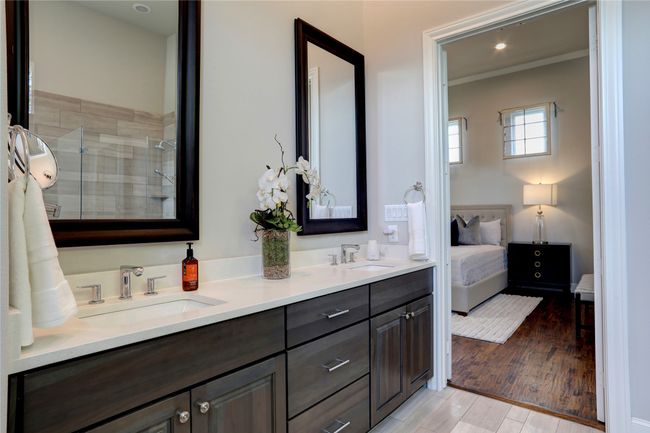 The ensuite Bathroom with its double vanities, and plenty of storage. | Image 13