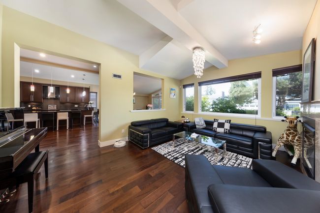 Living room featuring dark wood-style floors, baseboards, a chandelier, and recessed lighting | Image 9